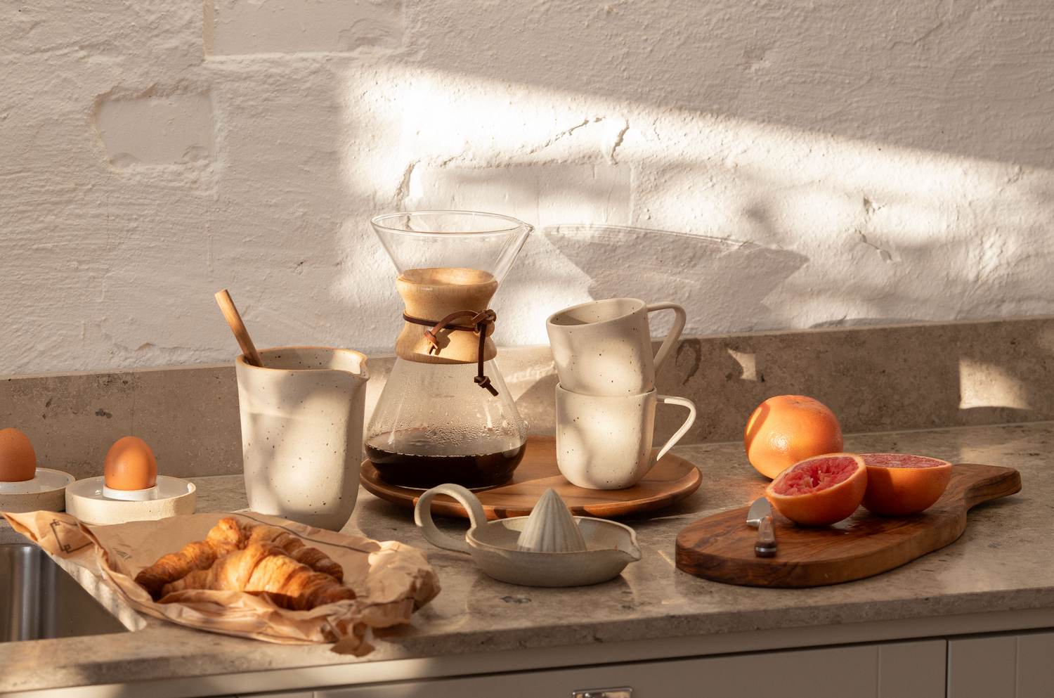 Handmade ceramics eating breakfast with fruit and croassant